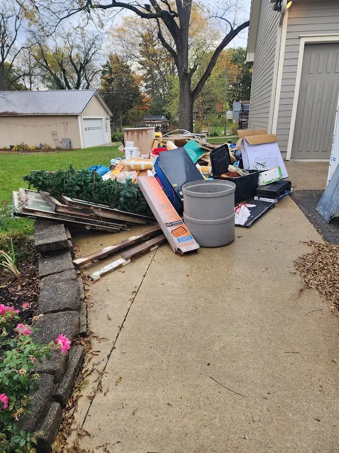 Dumpster being loaded with debris for 12 Yard Dumpster Rental in Newark Valley